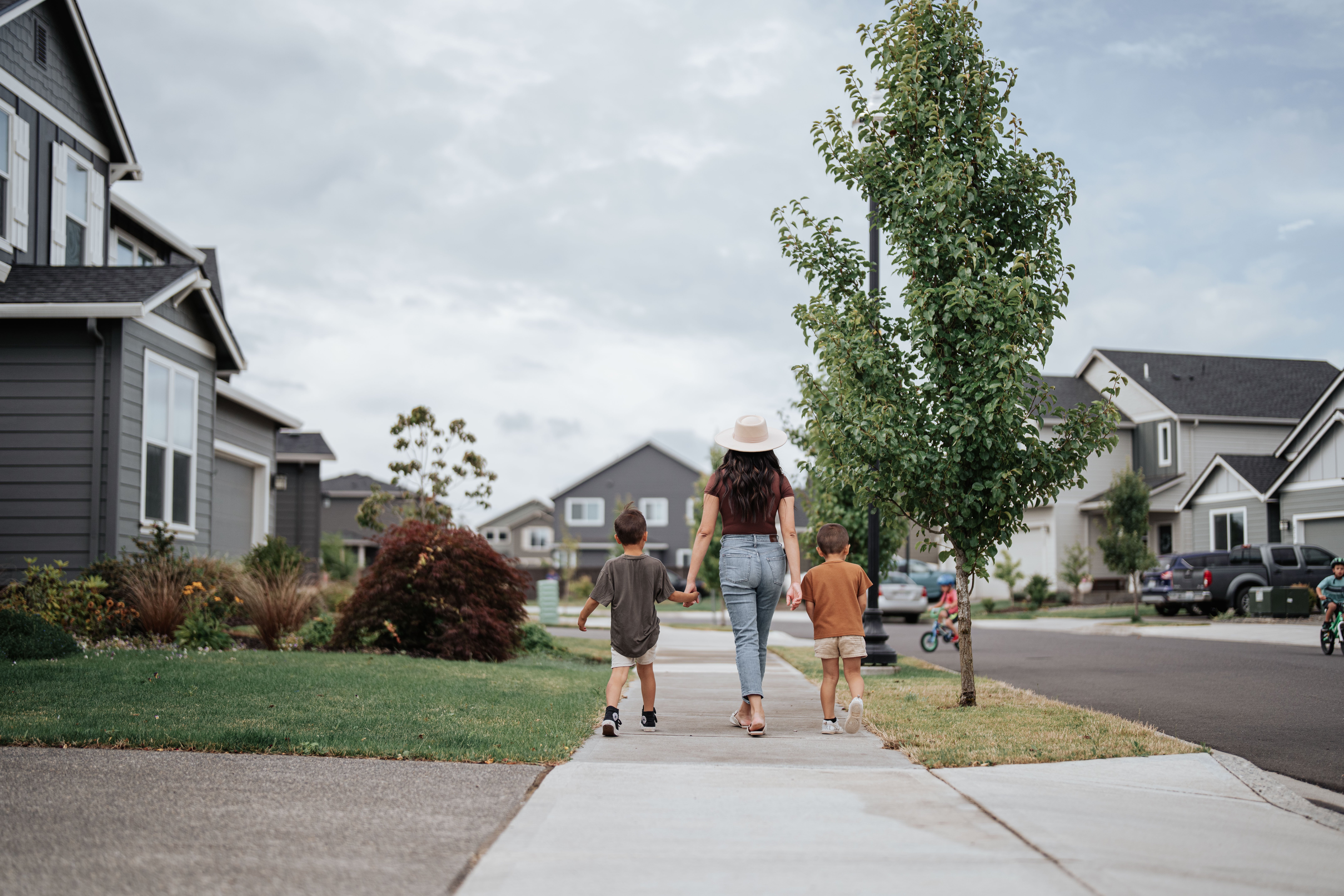family walking down the street of a Holt community